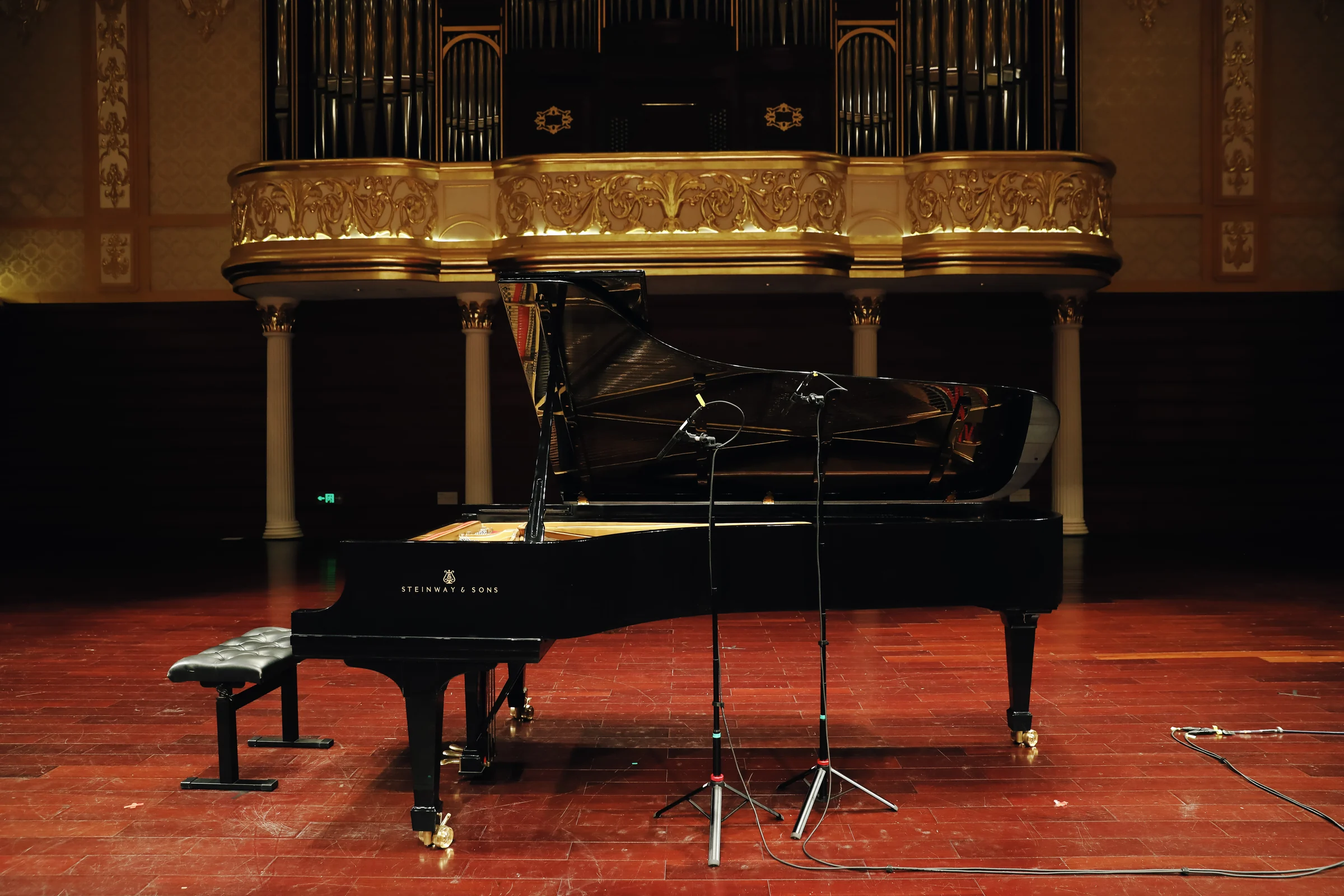 Steinway D274 and microphone stands on the empty stage
